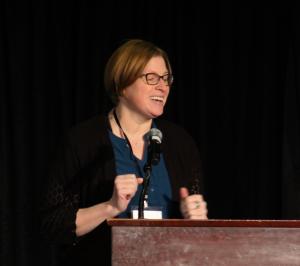 Carmen Quatman presenting on stage at the 2026 CTSI Annual Scientific Meeting