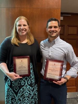 Dr. Quatman-Yates and Dr. Crick holding their awards.